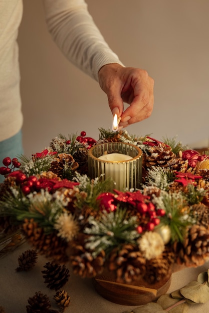 Free Photo woman lighting wreath candle on fire