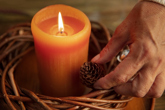 Woman lighting wreath candle on fire