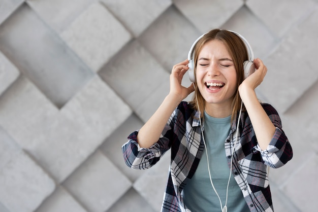 Free Photo woman listening music with copy space