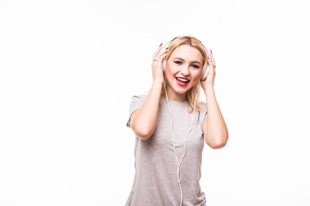 Woman listening to popmusic on headphones enjoying a dance