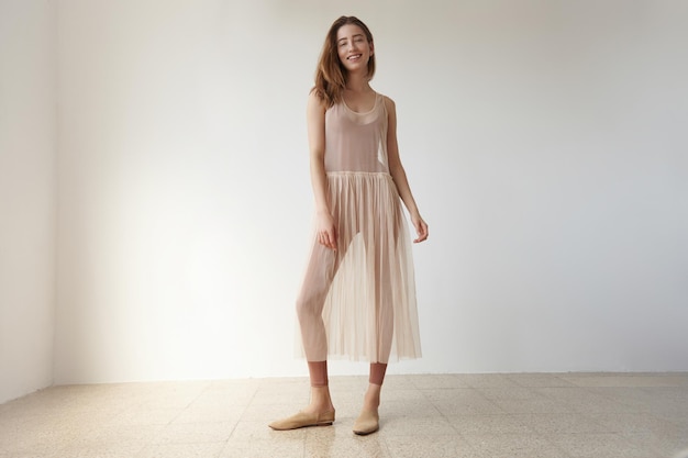 Free photo woman in loft studion in transparent ballerina's dress