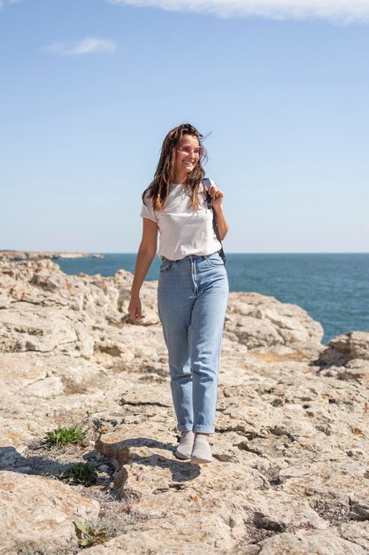 Woman looking away while walking at the beach