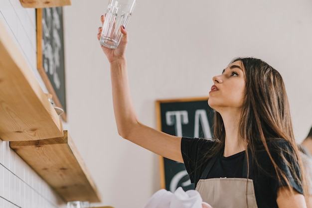 Woman looking at clean glass