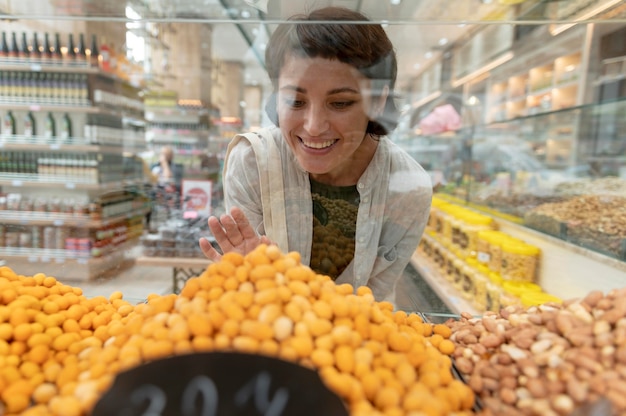 Free Photo woman looking for different goodies at a local producer