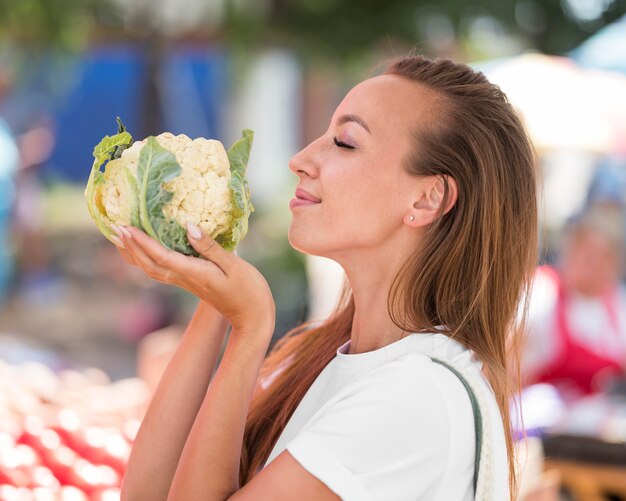 Woman looking for fresh cauliflowers