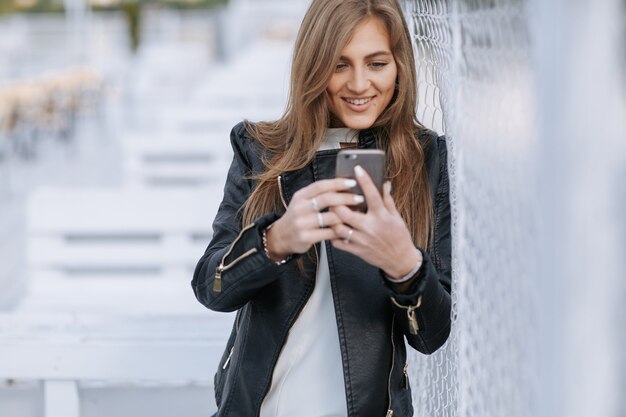 Woman looking at her smartphone and smiles