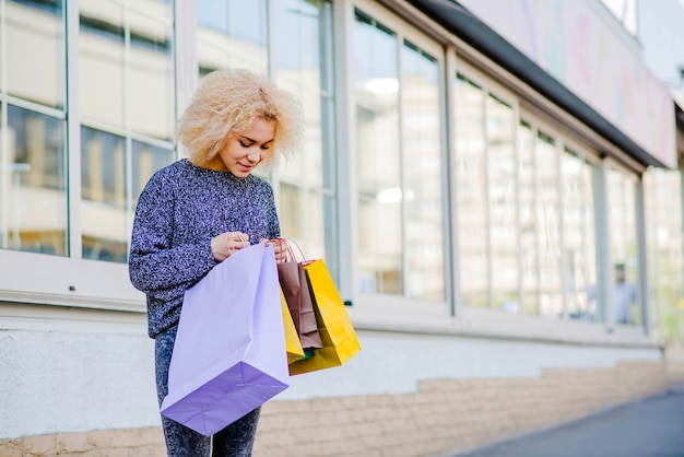 Free photo woman looking into shopping bag