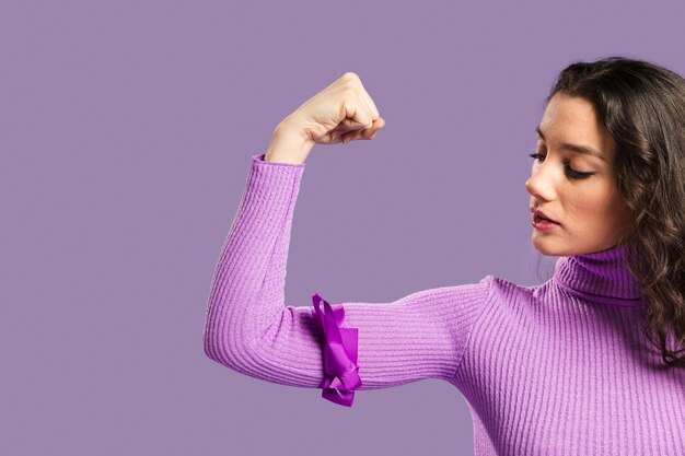 Woman looking proudly at her arms muscles