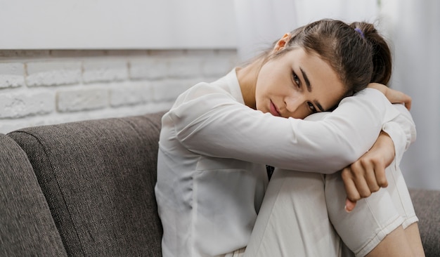 Woman looking sad as she works from home with copy space