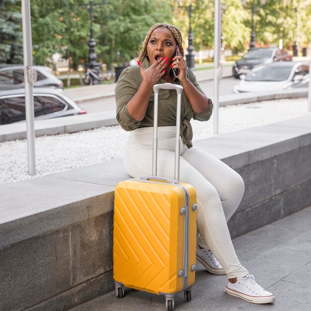 Woman looking shocked while talking on the phone outside