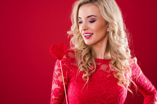 Woman looking at stick with felt heart