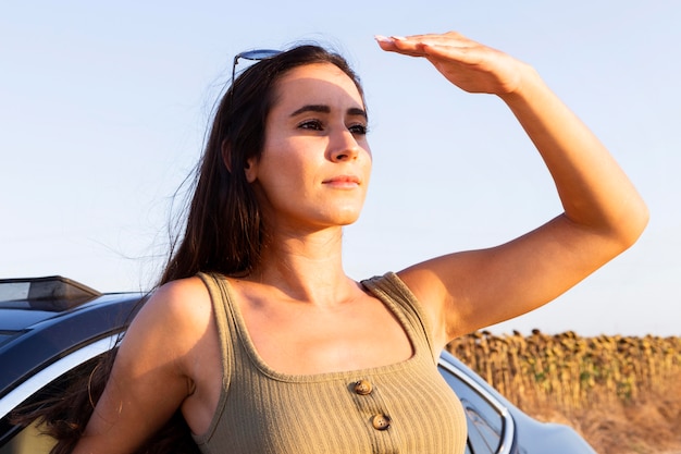 Woman looking at the sun while enjoying nature