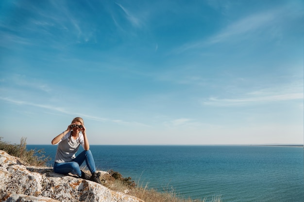 Woman looking through binoculars