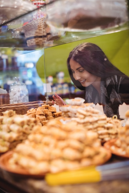 Free Photo woman looking at turkish sweets in shop