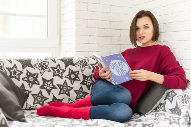 Woman looking up from book