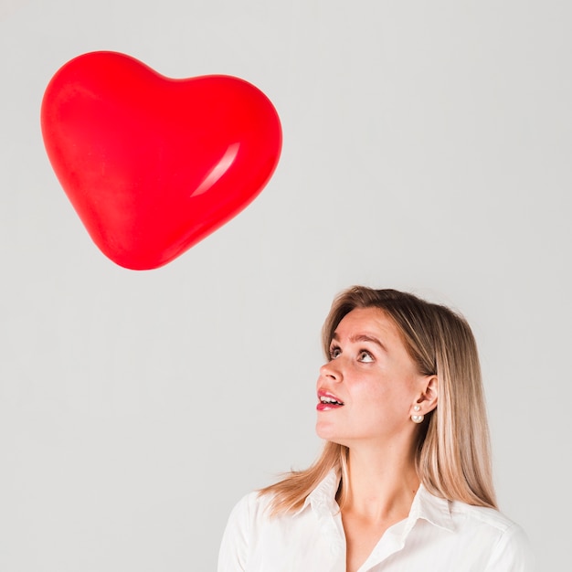 Free Photo woman looking at valentines balloon