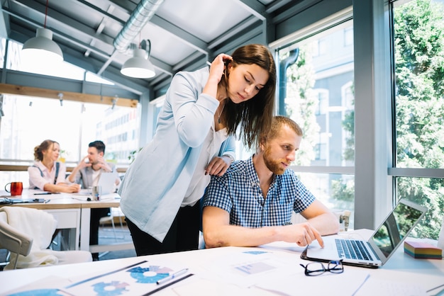 Woman looking at work of man