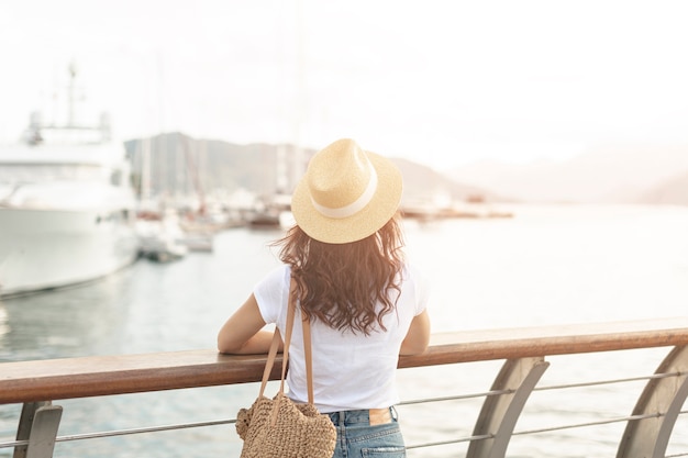 Woman lookint at ships on sea