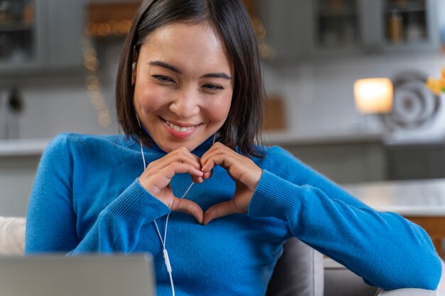 Woman in love with laptop at home medium shot