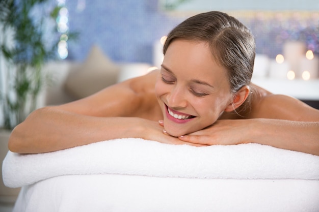 Woman lying in massage room smiling