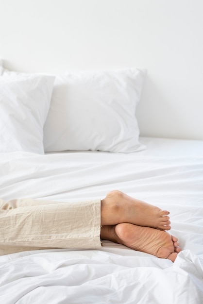 Woman lying on a white mattress on the floor