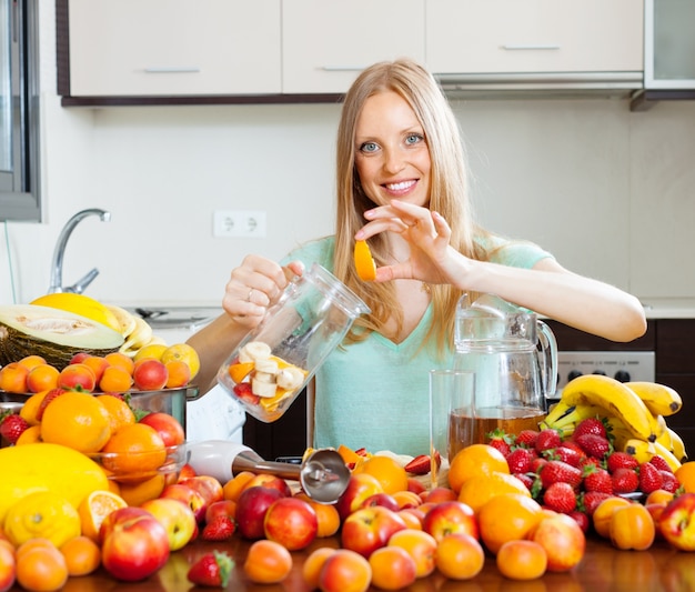 Free photo woman making beverages from fruits