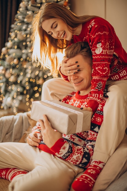 Woman making a christmas present to her boyfriend