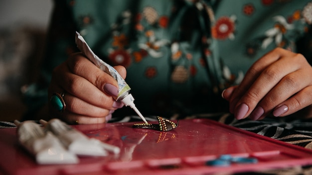 Woman making crafts with the help of glue