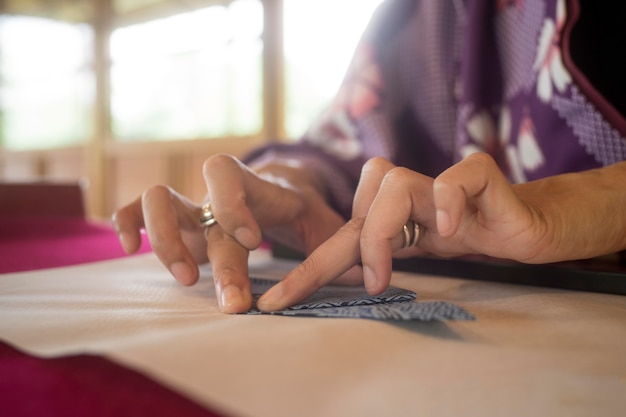 Woman making origami with japanese paper