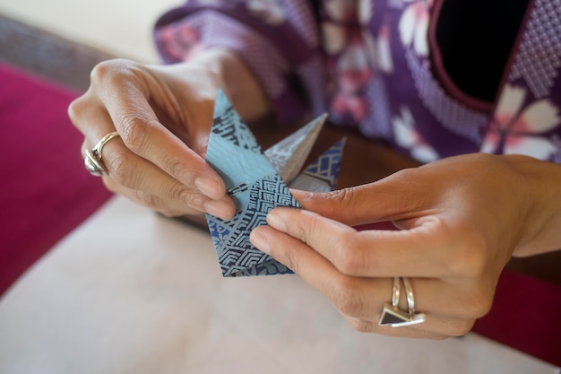 Free Photo woman making origami with japanese paper