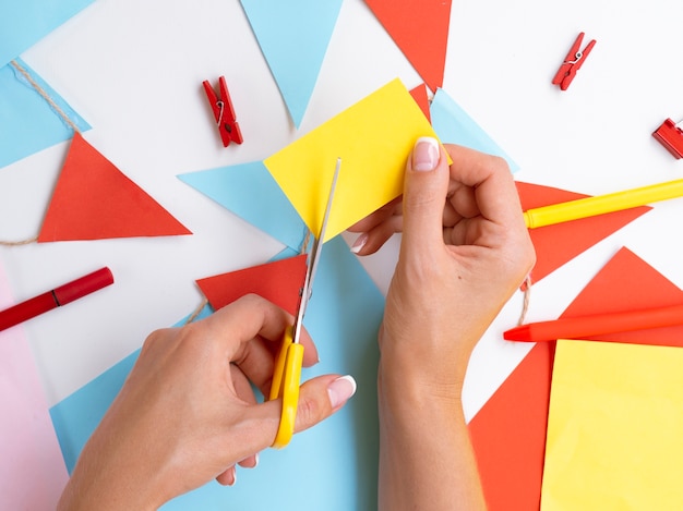 Woman making paper and clips decorations