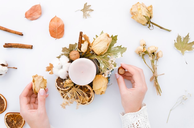 Free photo woman making rustic candle decoration