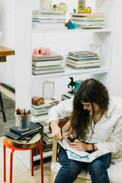 Woman making sketches at home