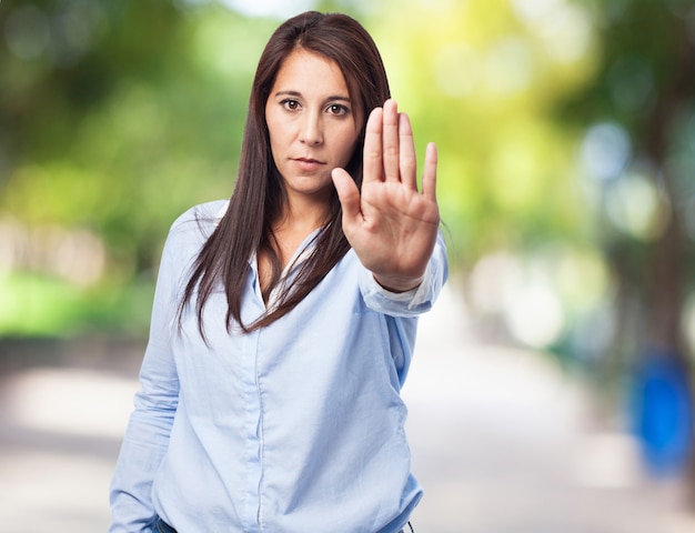 Woman making a stop sign with a hand