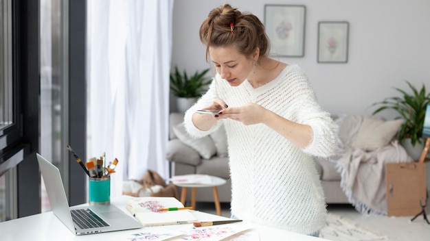 Woman making a vlog of her drawings