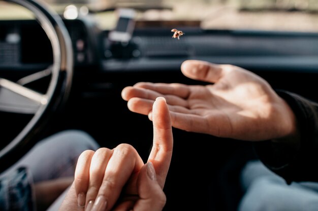 Woman and man looking at a small insect close-up