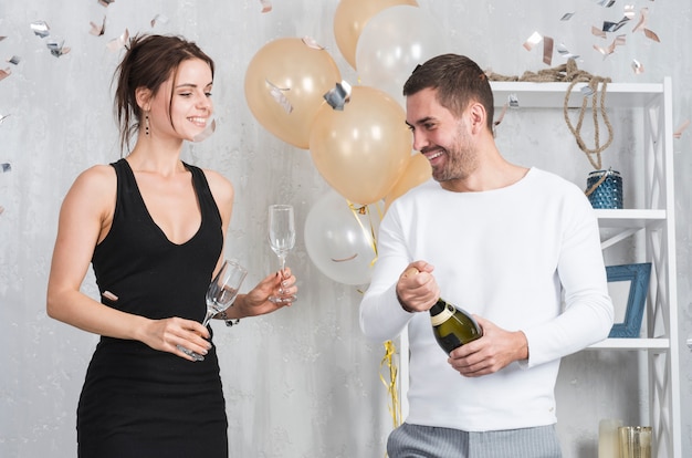 Woman and man preparing for drinking champagne