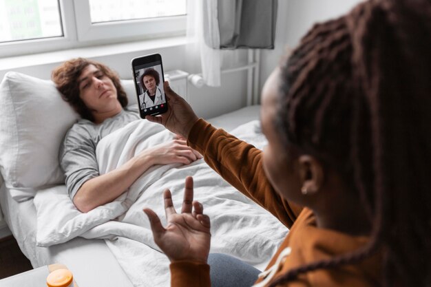 Woman and man talking with a doctor by videocall