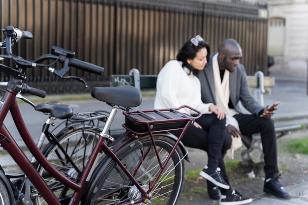 Woman and man using smartphone in the city in france