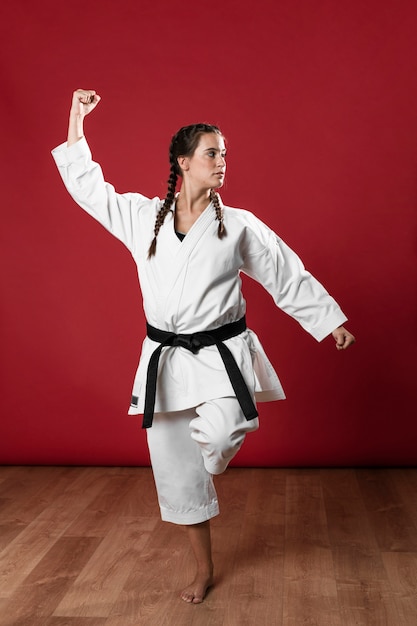 Free photo woman in martial arts uniform exercising karate