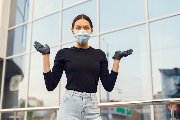 Woman in a mask stands on the street