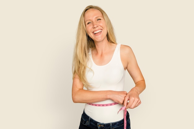 Woman measuring waist  for health and wellness campaign