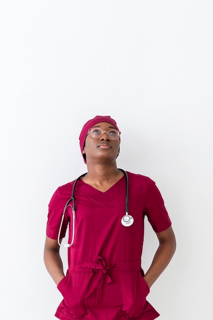 Woman medic in red uniform looking up