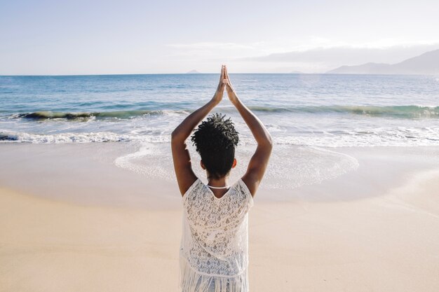 Woman meditating at the beach