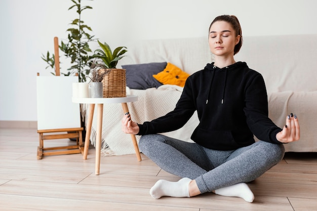 Free photo woman meditating indoor