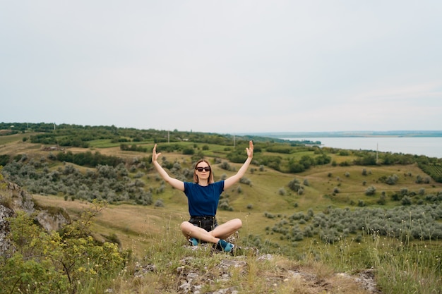 Free Photo woman meditating relaxing alone. travel healthy lifestyle with beautiful landscape