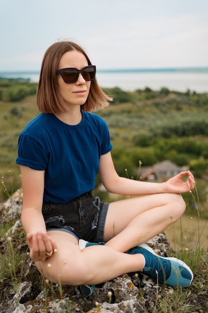 Free Photo woman meditating relaxing alone.