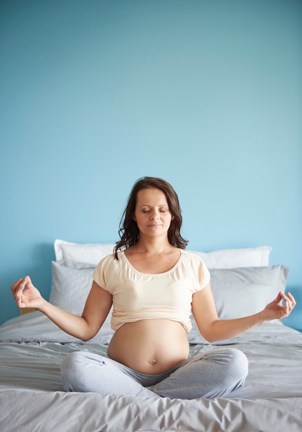 Woman meditating while being pregnant