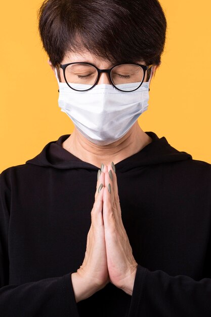 Woman meditating with a face mask on