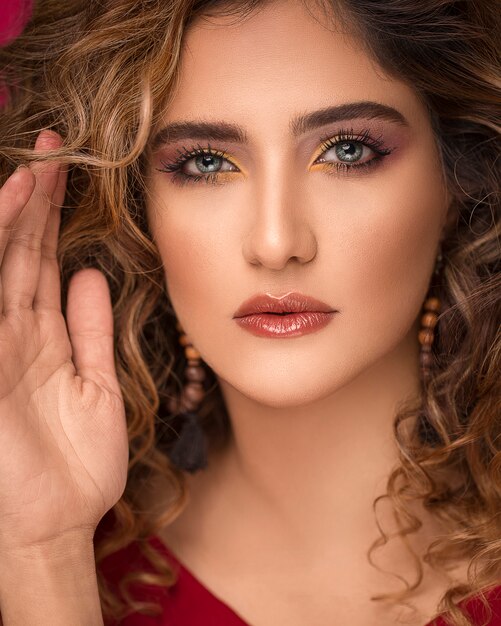 Woman model with blonde curly hairs and chic makeup